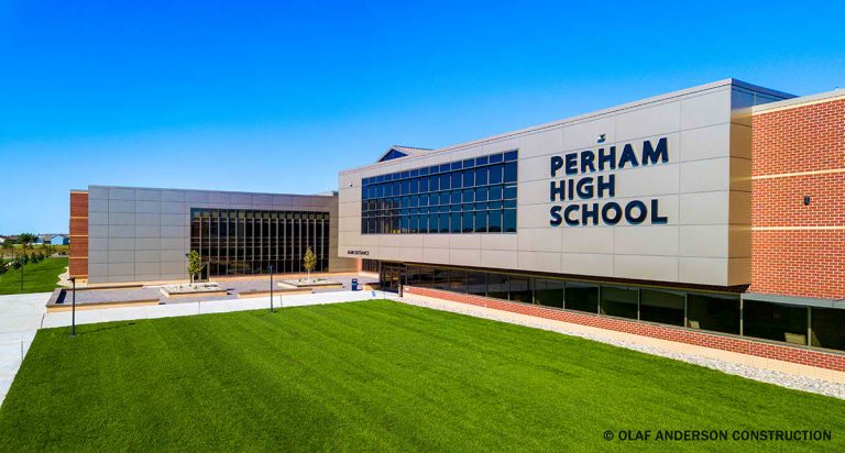 This is the Perham High School building with a bright green lawn out front.
