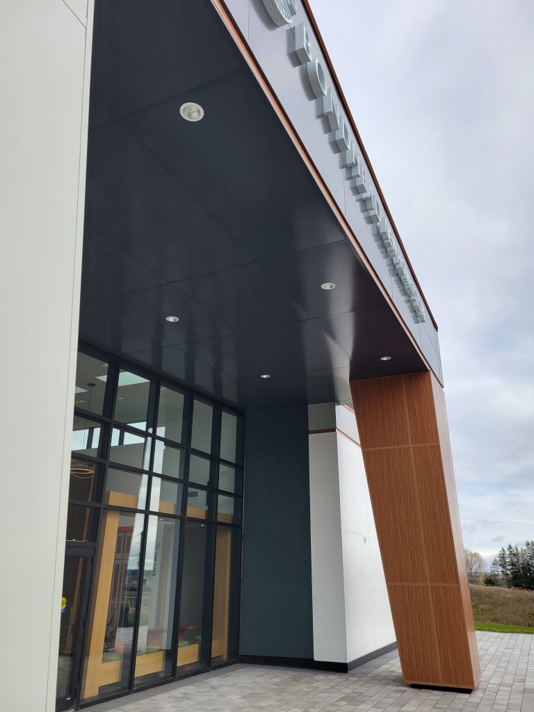 Entrance to building with soffits in black panel