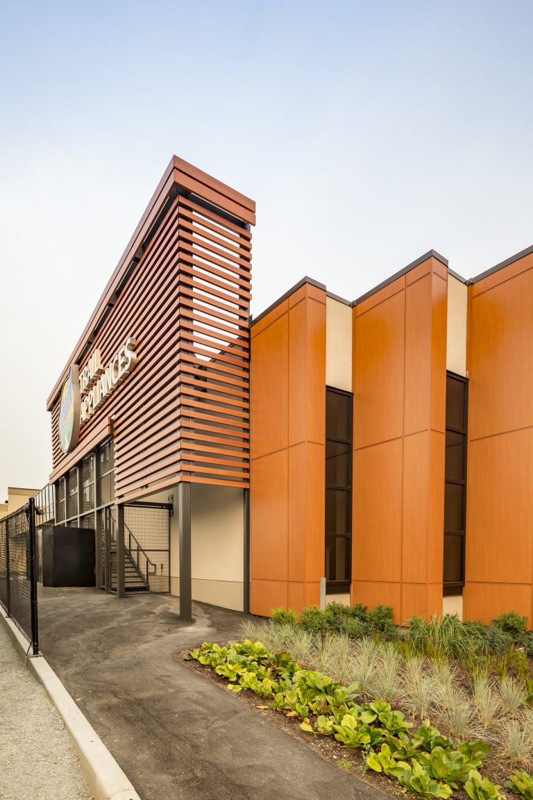 Store with 3 columns of vertical orange metal panels